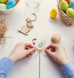A person is making an easter decoration